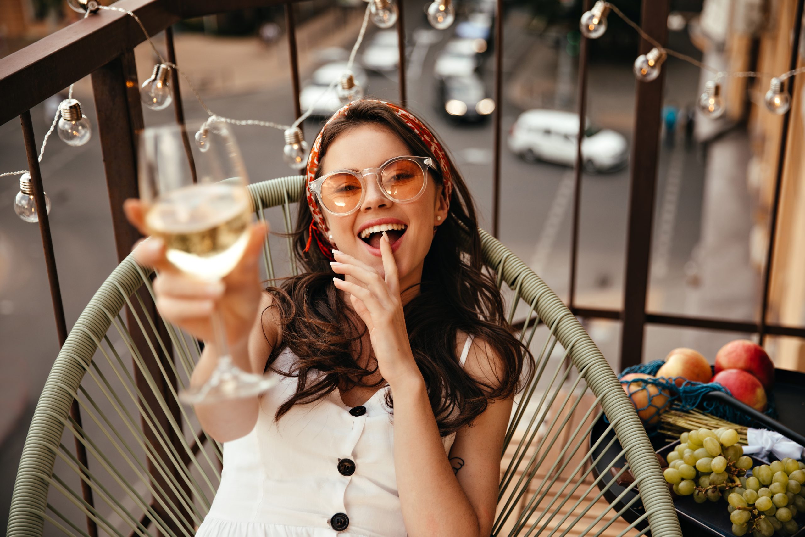 Brunette,Lady,In,Orange,Sunglasses,Rests,On,Balcony,With,Champagne
